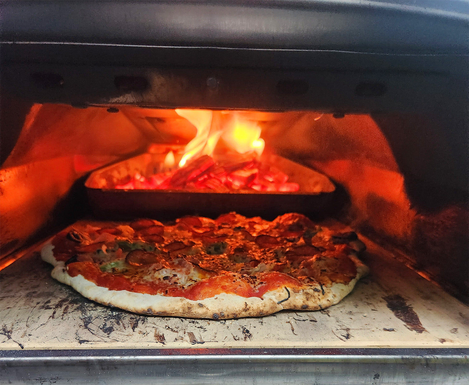 picture of wood fired pizza oven with pizza